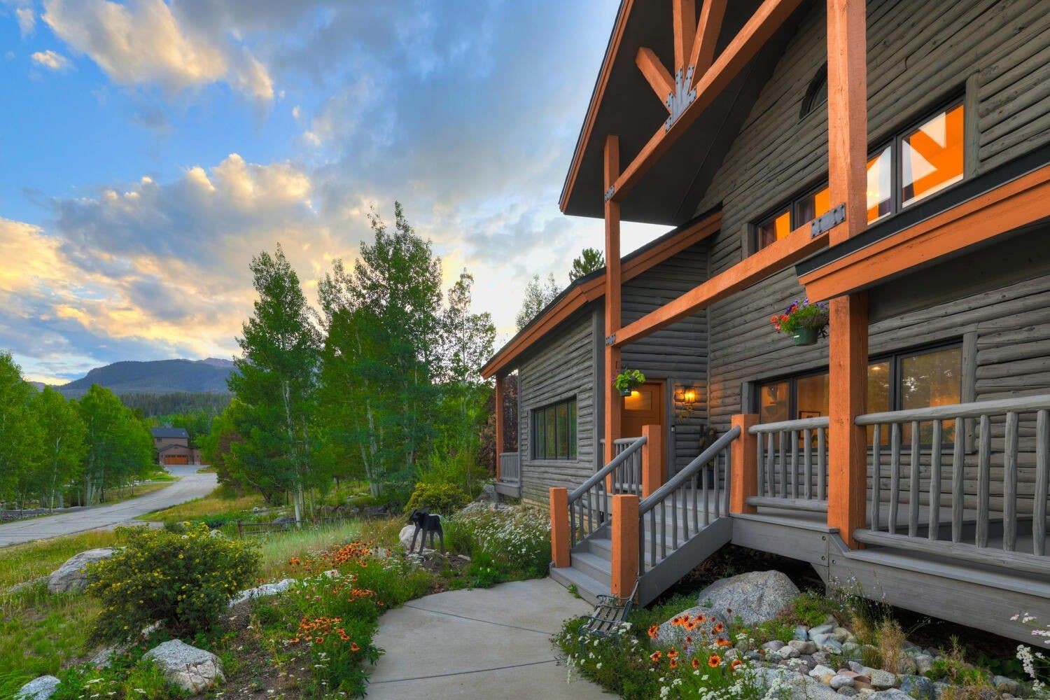 Front porch and summer wildflower gardens of the mountain home, with the Gore Range behind